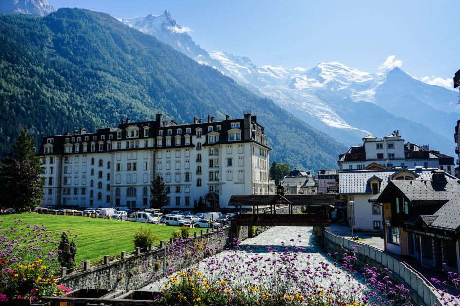 Chamonix town with the Arve River flowing through and snow-capped Mont Blanc massif in the background.