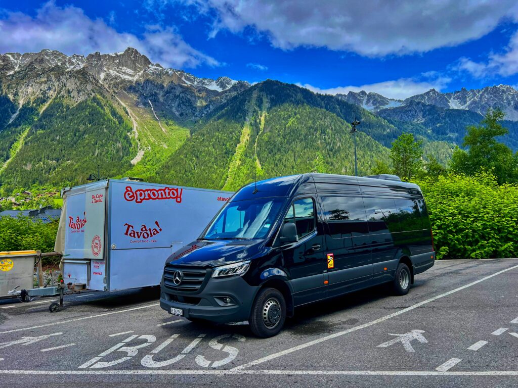 Black Mercedes Sprinter van from GVAtoALPS in Chamonix with mountains in background, ready for alpine transfer.
