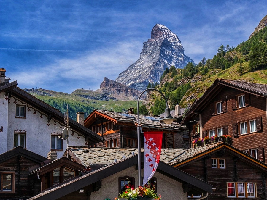 Traditional Swiss chalets in Zermatt with the Matterhorn mountain in the background, captured on a sunny day